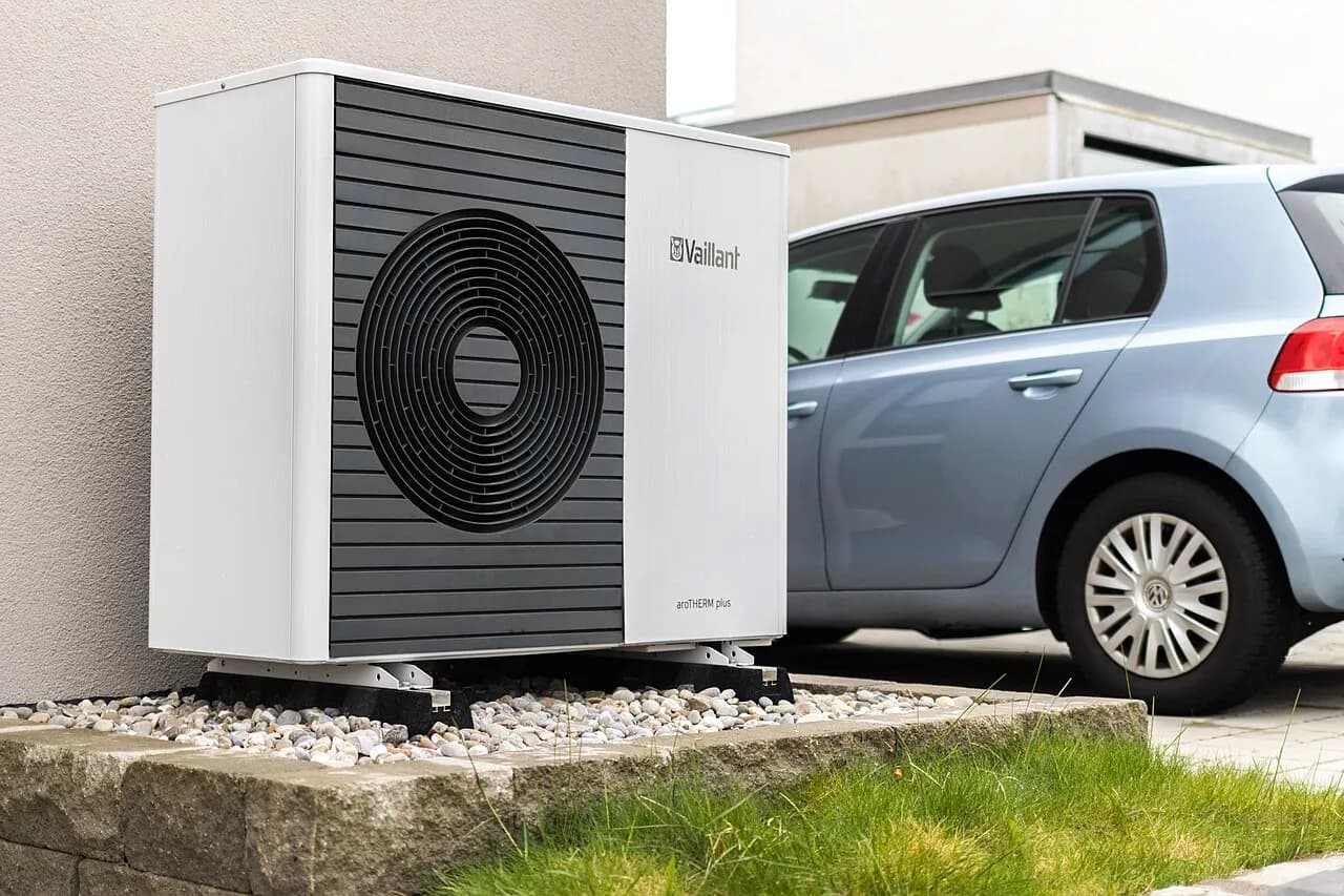 Outdoor unit of an air-to-water heat pump beside a building
