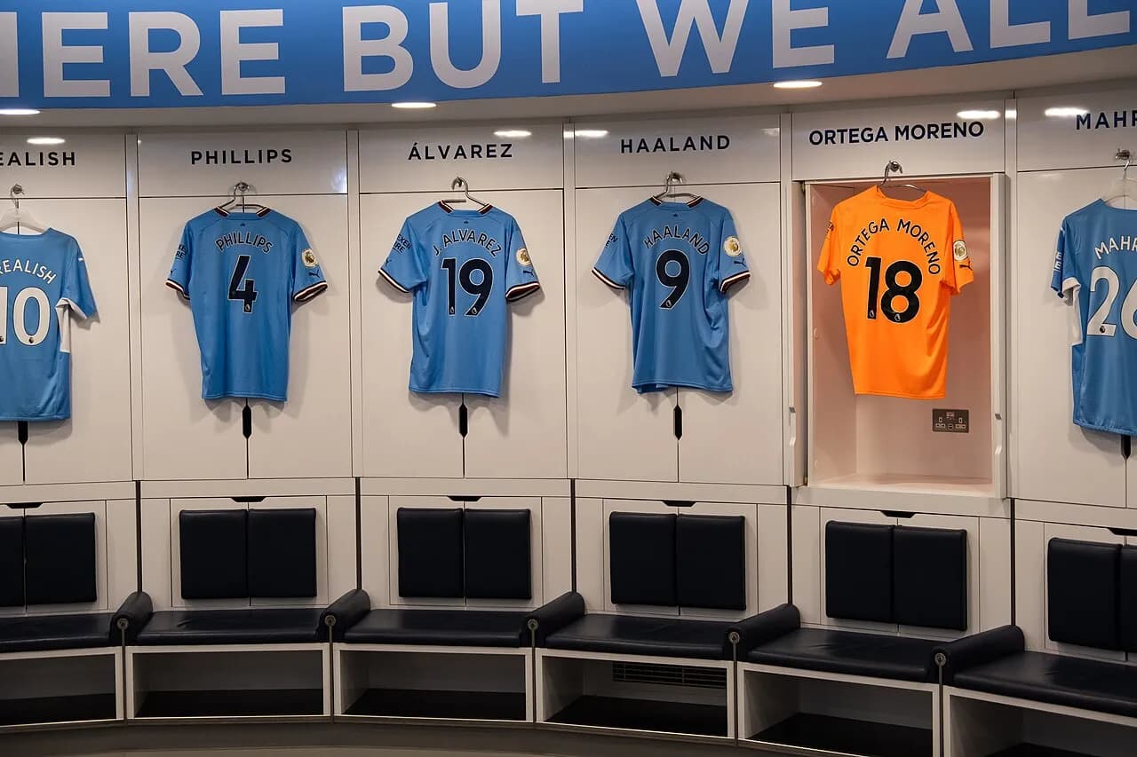 Manchester City football shirts hanging in the dressing room at Etihad Stadium