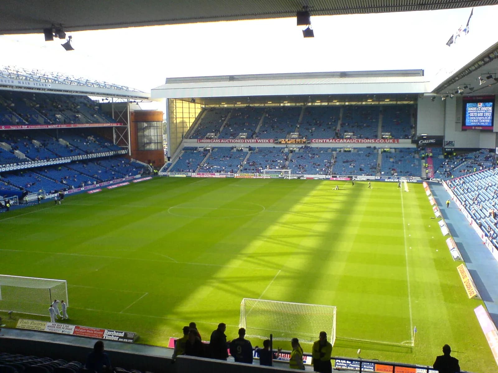 Interior of Ibrox Stadium during a matchday, with spectators in the stands.