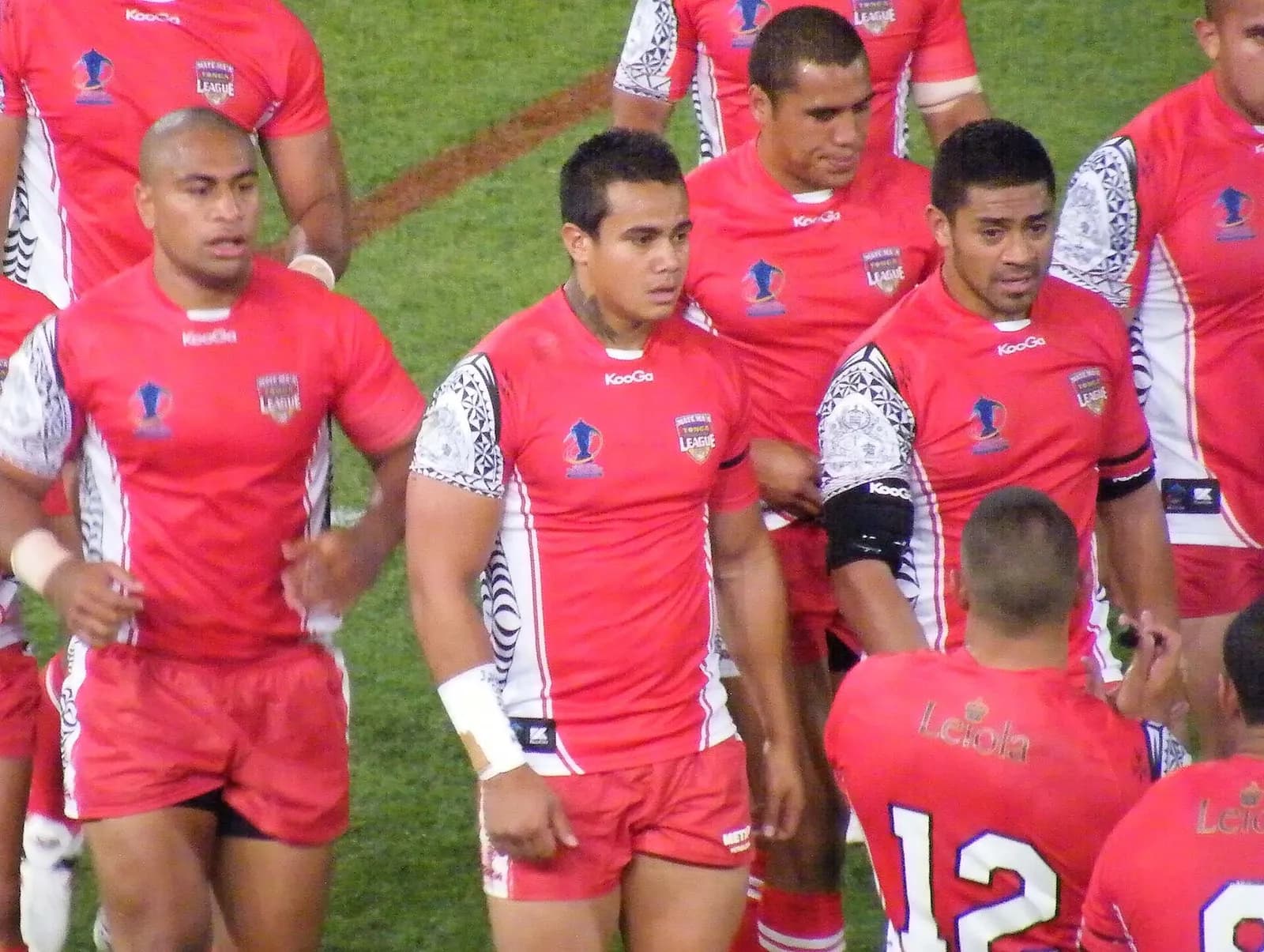 Tonga rugby league players Lopini Paea, Esi Tonga and Willie Manu leave the field at half-time.