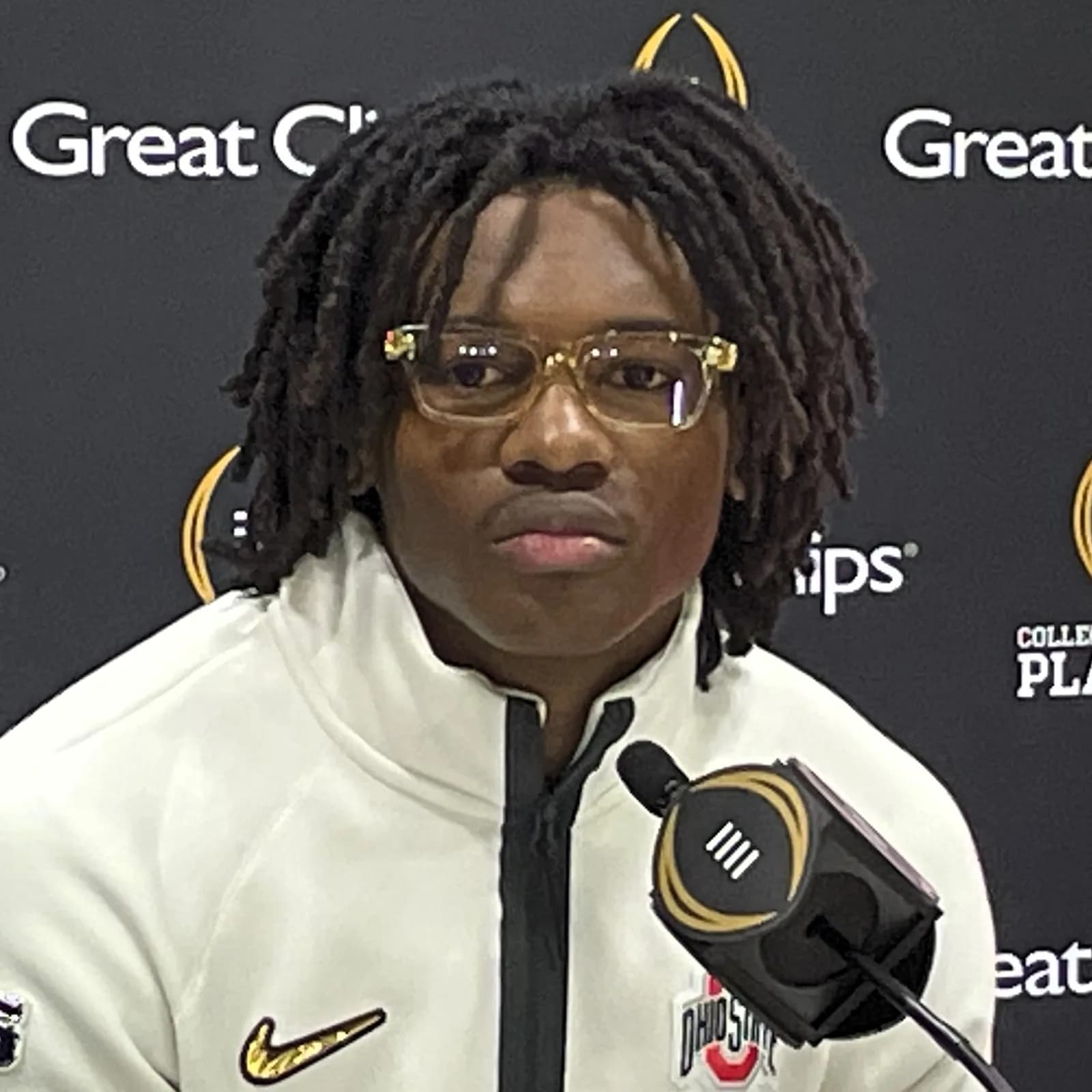 Ohio State wide receiver Jeremiah Smith at a press conference, seated before a microphone.