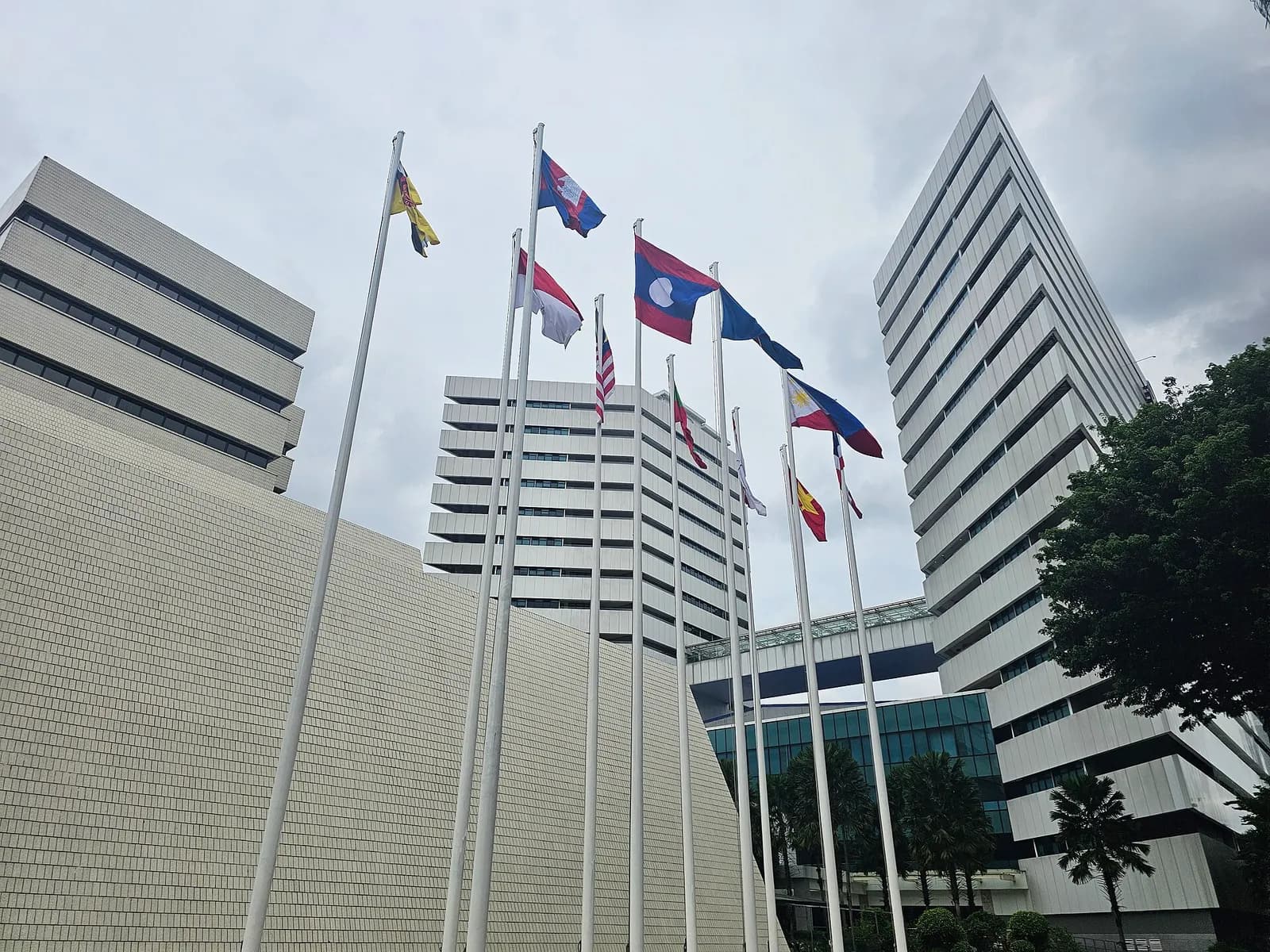 ASEAN Secretariat buildings in Jakarta with ASEAN flags outside.