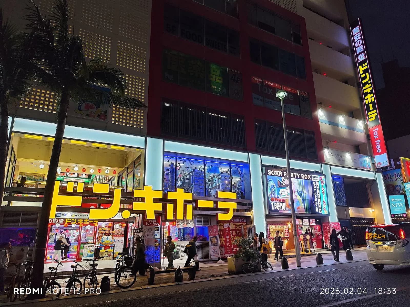 A nighttime view of a commercial street in Naha, Okinawa.