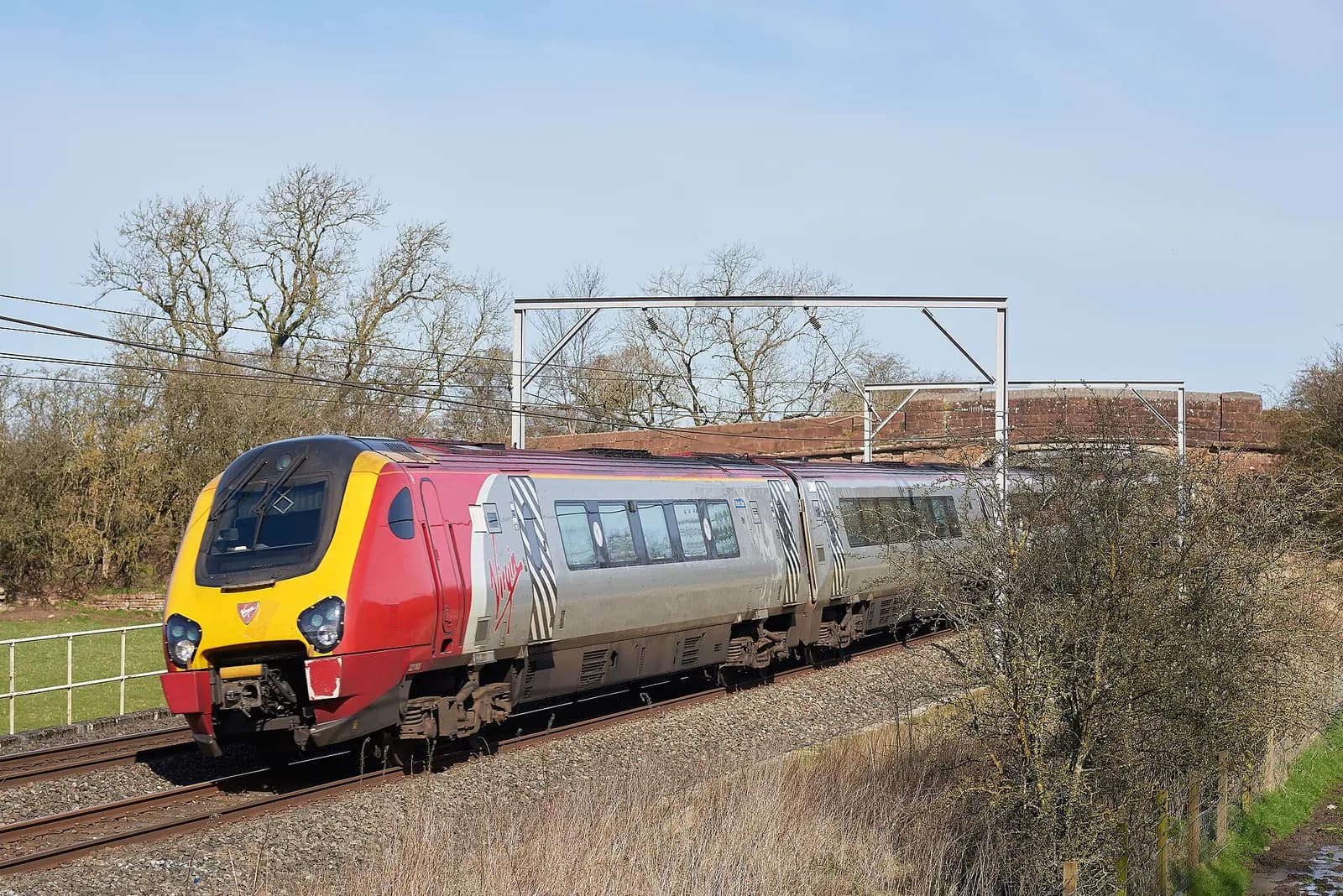 A Virgin Trains Voyager travelling on the West Coast Main Line at Kettleside Bridge.