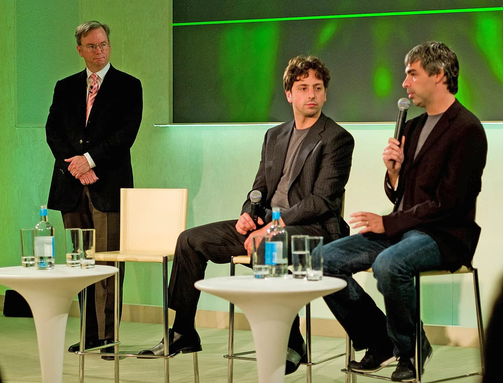 Sergey Brin, Eric Schmidt and Larry Page stand together at a Google event.