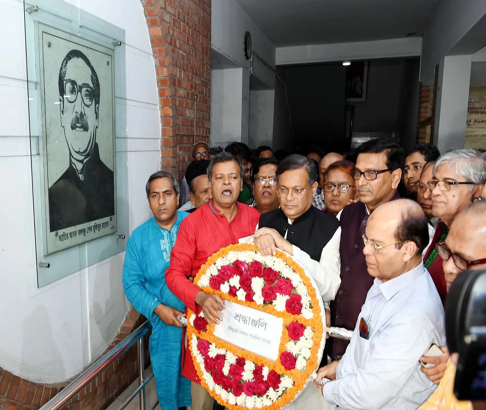 Mahbubul Alam Hanif stands with Hasan Mahmud and Mustafa Jabbar at the National Press Club in Dhaka.