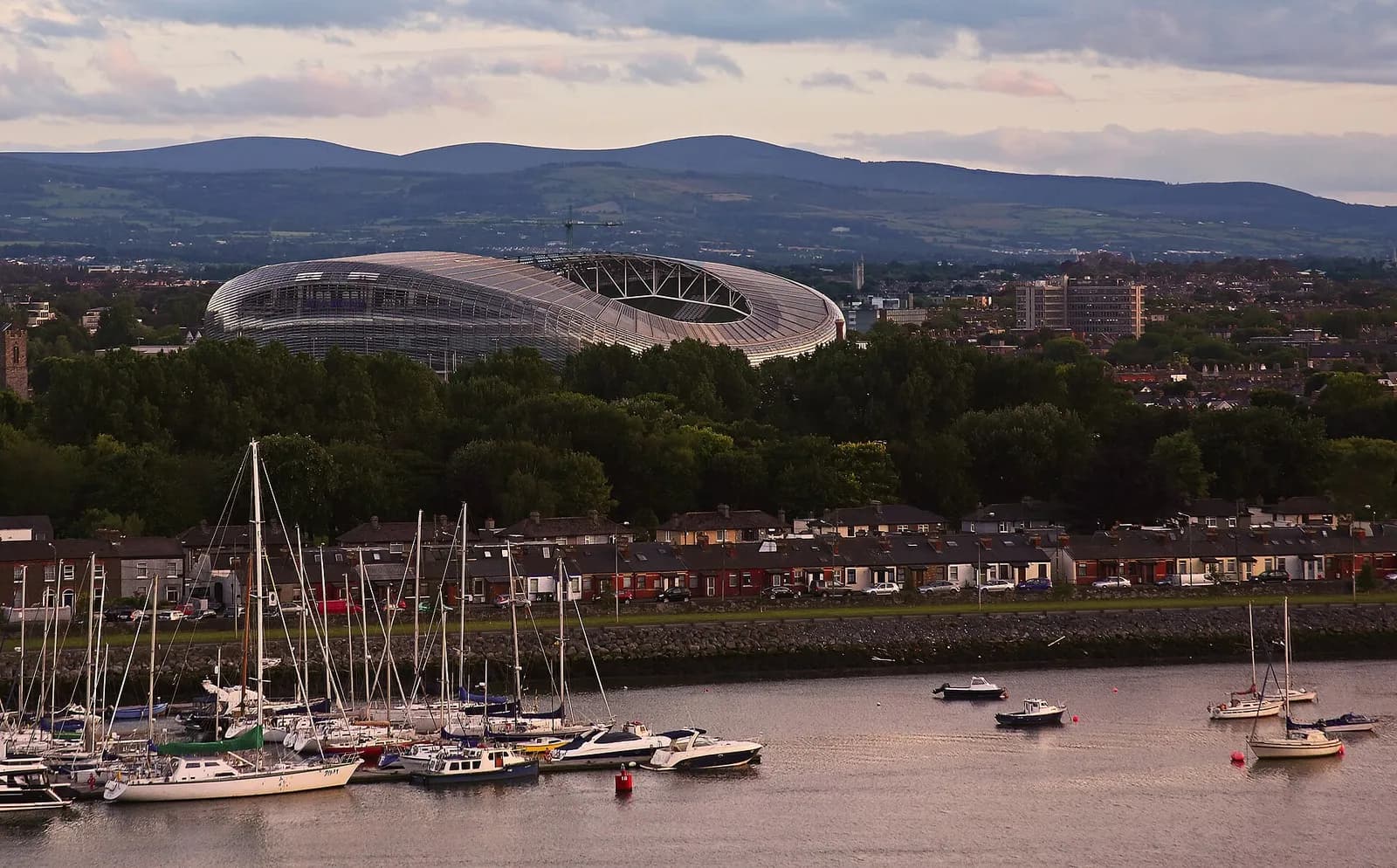 View of Aviva Stadium in Dublin, with sailboats in the foreground.