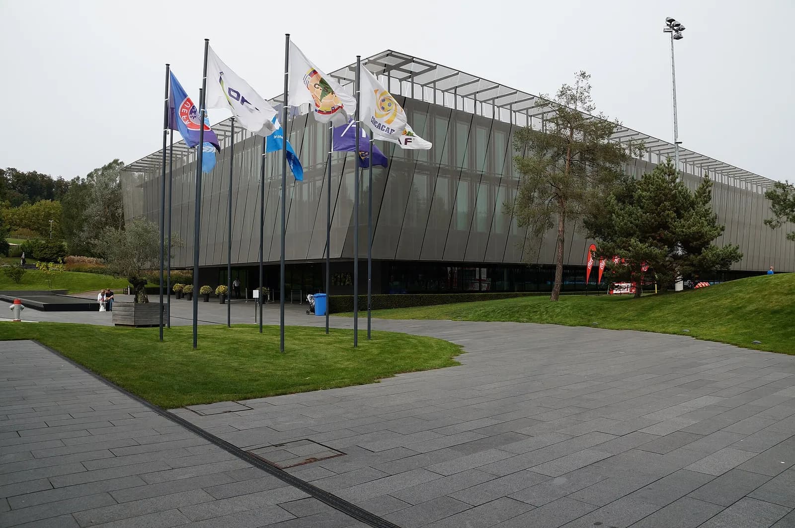 The FIFA headquarters building with flags outside in Zurich.