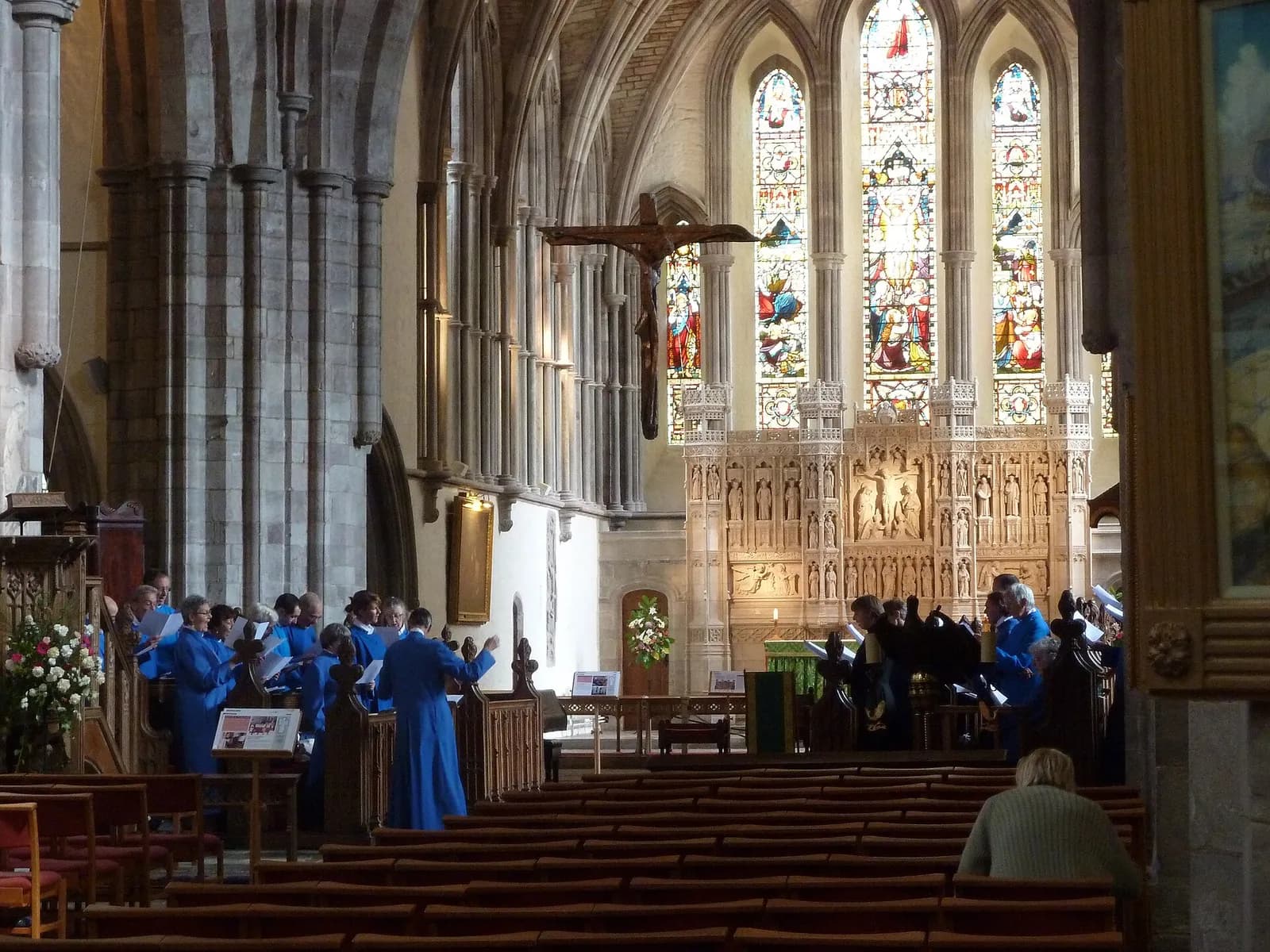 A choir rehearses inside Brecon Cathedral.