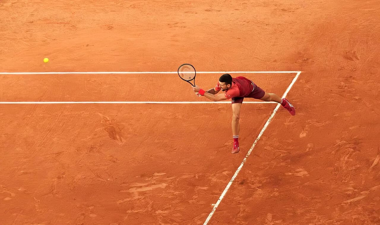 Novak Djokovic playing a backhand during a tennis match