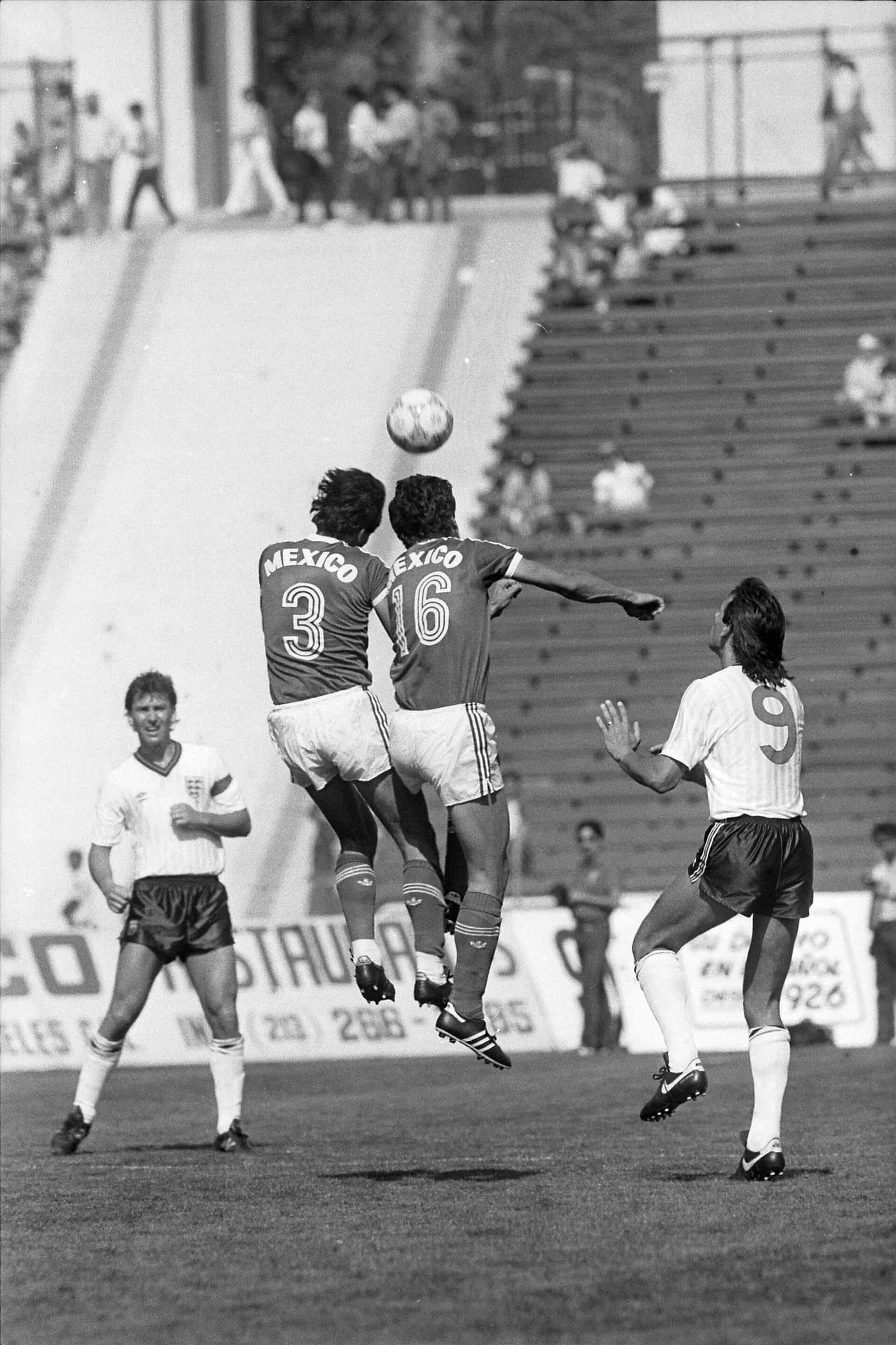 Two Mexican players contest a header against England during a football match at Los Angeles Coliseum in 1986.