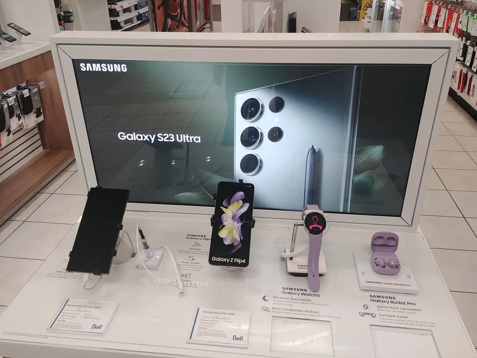 Samsung phone and Galaxy Watch displayed with other Samsung devices.
