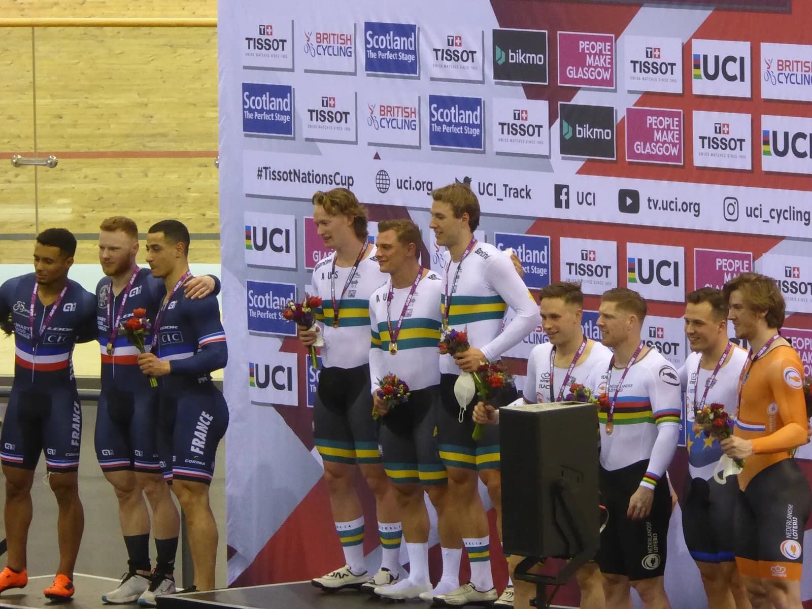 The Australian men's team sprint riders stand on the podium between the French and Dutch teams at the 2022 UCI Track Nations Cup in Glasgow; Leigh Hoffman is among the Australians.