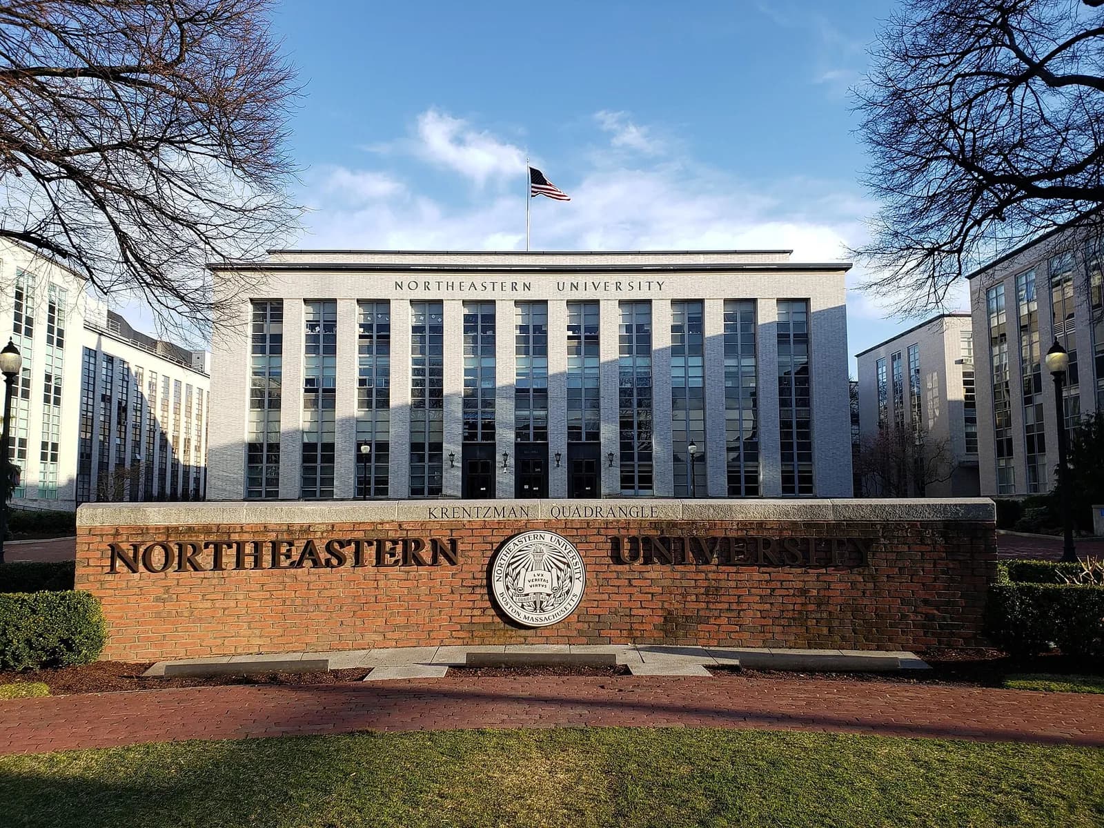 Northeastern University sign at Krentzman Quad, with Ell Hall behind it.