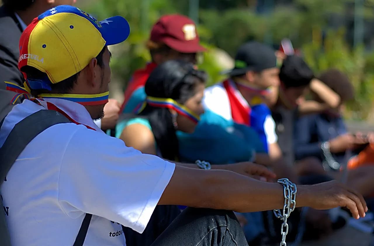 Young protesters chained together at Plaza Francia in Caracas during a 2014 demonstration calling for detained protesters' release