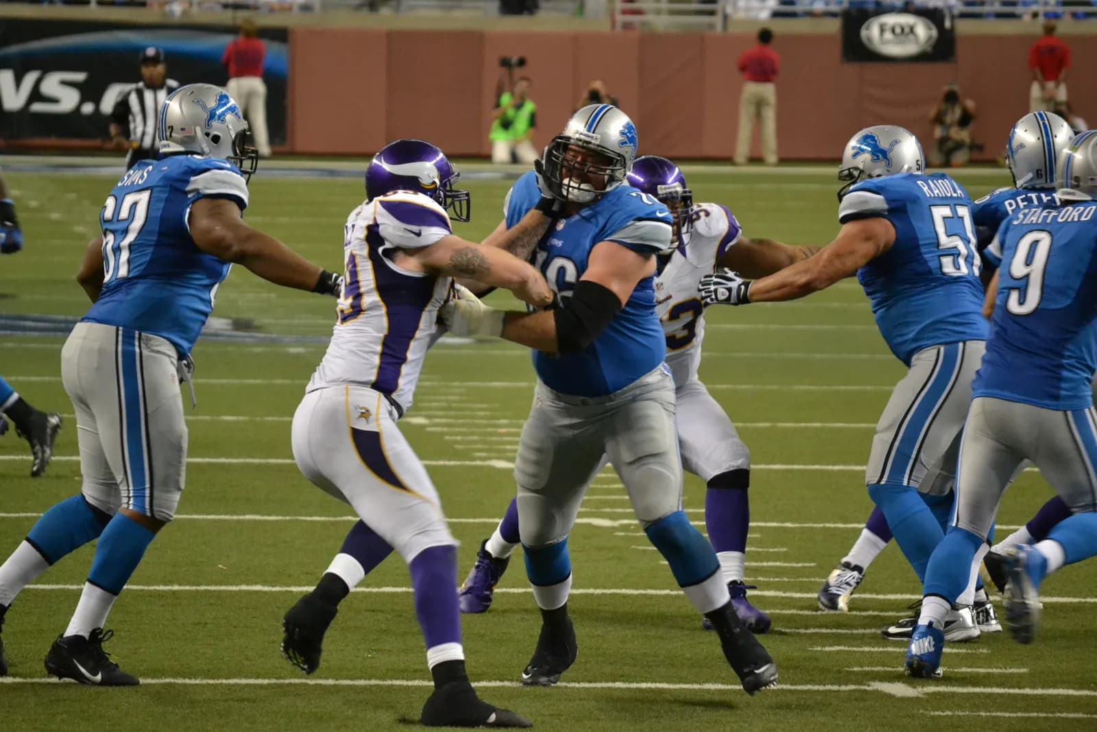 Detroit Lions and Minnesota Vikings players during game action at Ford Field.