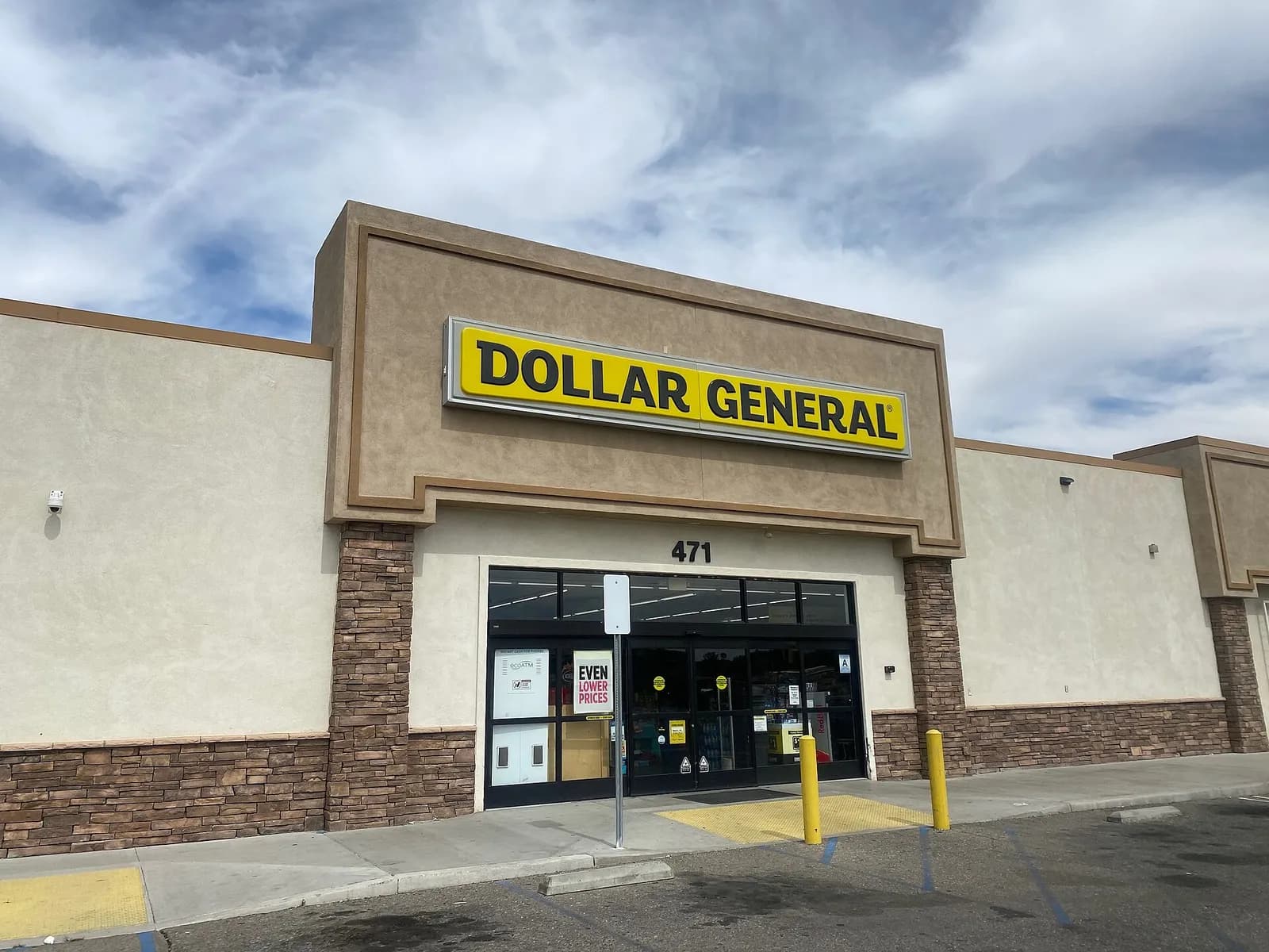 Exterior entrance and storefront of a Dollar General store in Barstow, California.