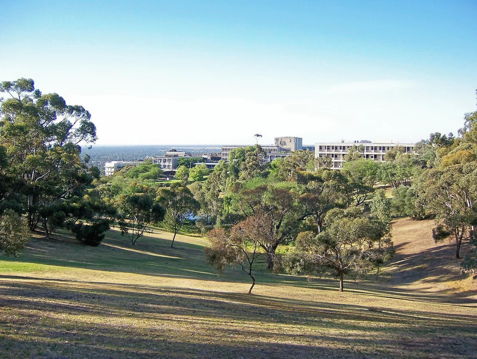 View over Flinders University’s main campus and lake from a hill.