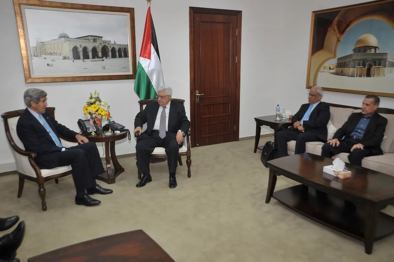 Mahmoud Abbas speaks with U.S. Secretary of State John Kerry at the Palestinian Authority headquarters in Ramallah.