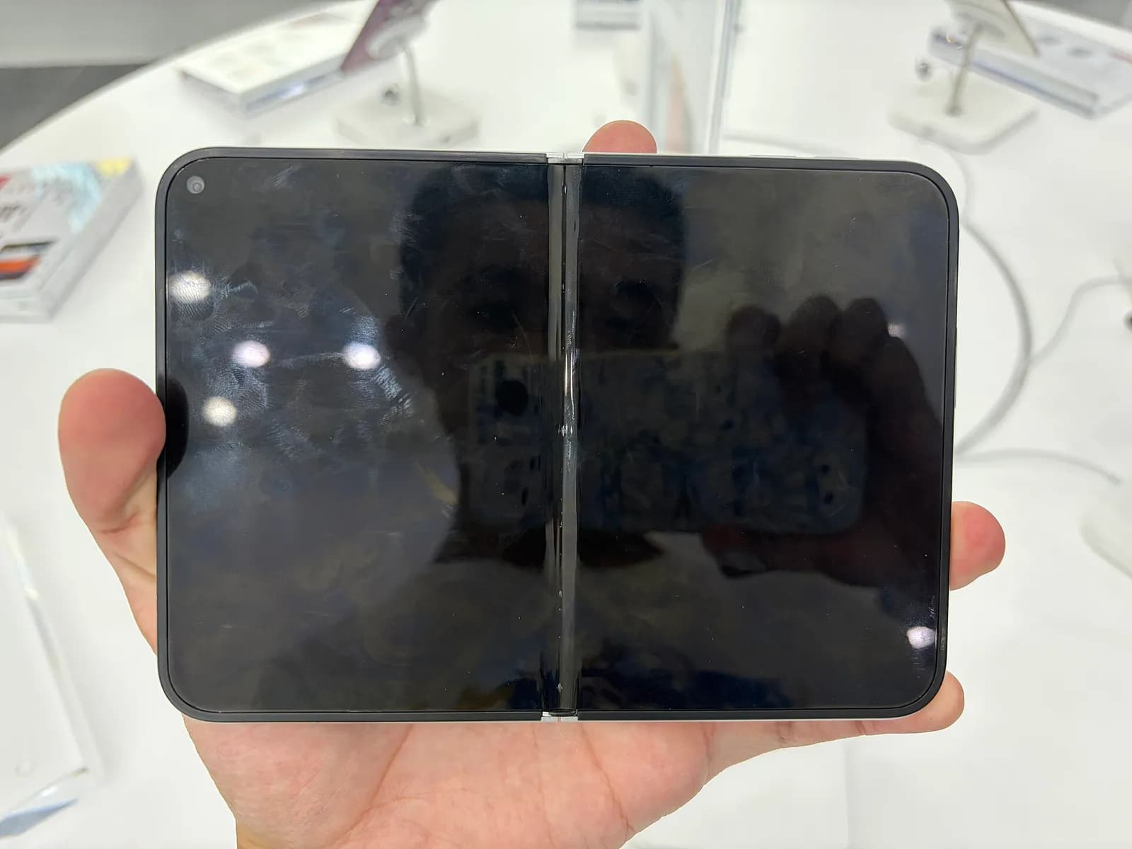 An Apple iPhone Duo open flat, showing its inner display.