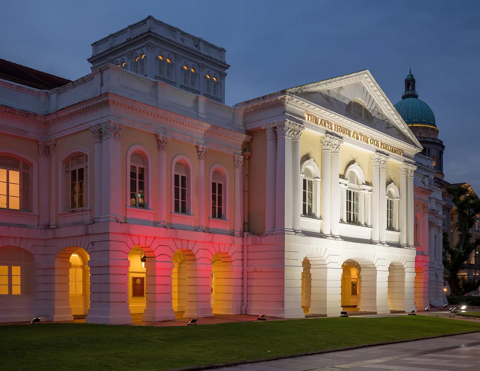 Exterior of The Arts House, formerly the Old Parliament House, in Singapore at blue hour.