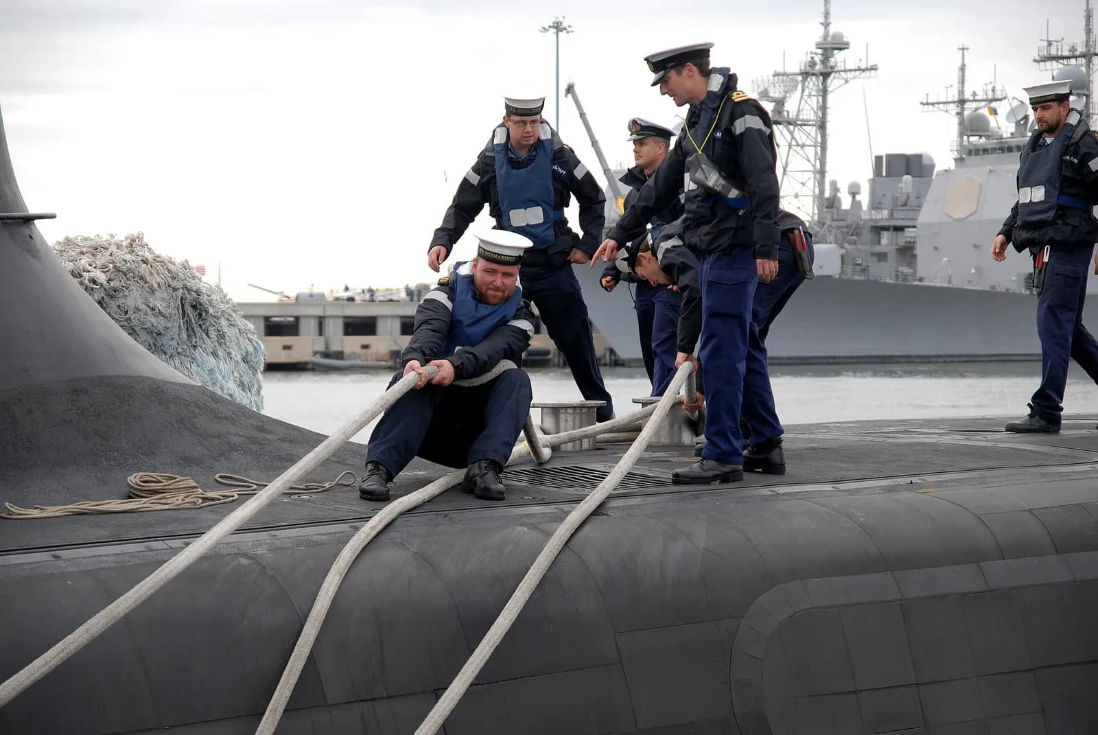 Sailors tend mooring lines on the Royal Navy submarine HMS Astute as it arrives at Naval Station Norfolk.