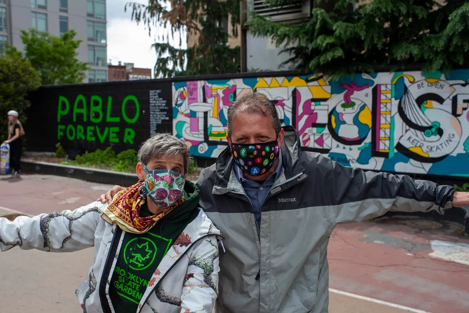 Brad Lander and Loren Michelle pose in front of the Pablo Forever mural.