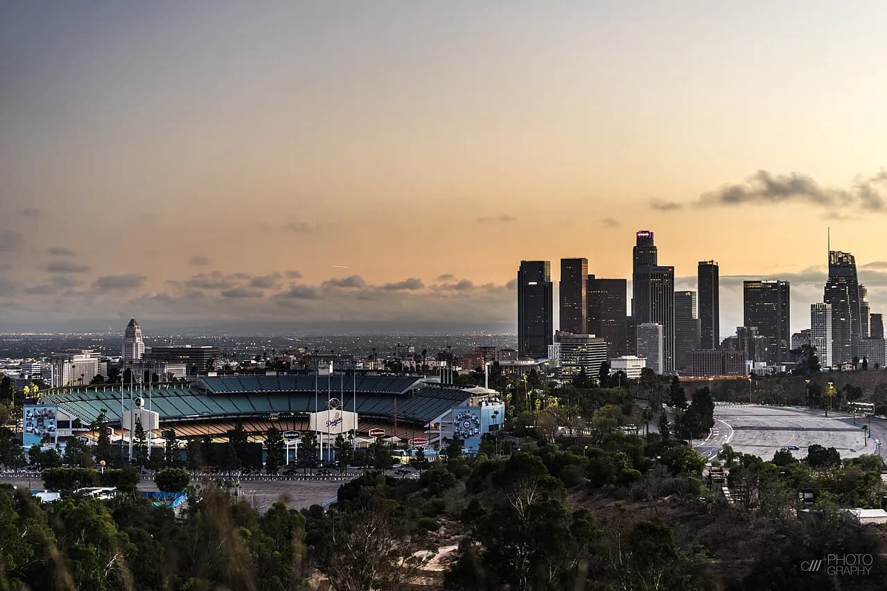 Dodger Stadium at sunset with downtown Los Angeles in the background