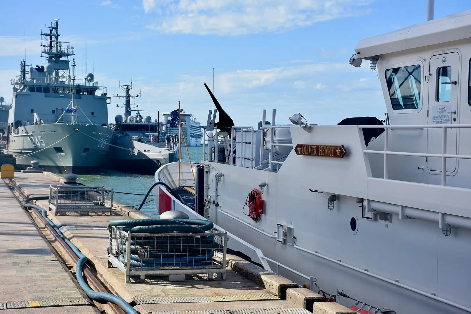 The USCGC Oliver Henry moored in Cairns, with HMAS Leeuwin and Cape Otway nearby.