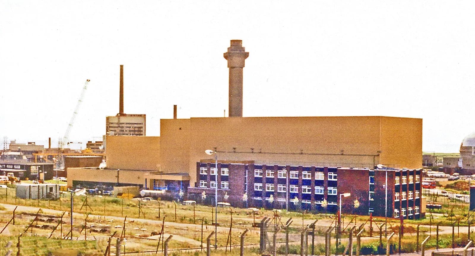 A view of the Sellafield nuclear reprocessing facility, including its industrial buildings and chimney.
