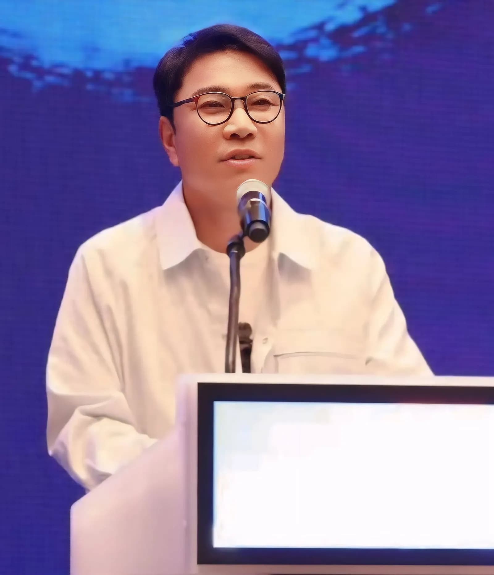 AI-upscaled file photograph of Lee Soo-man speaking at the CISAC in 2024.