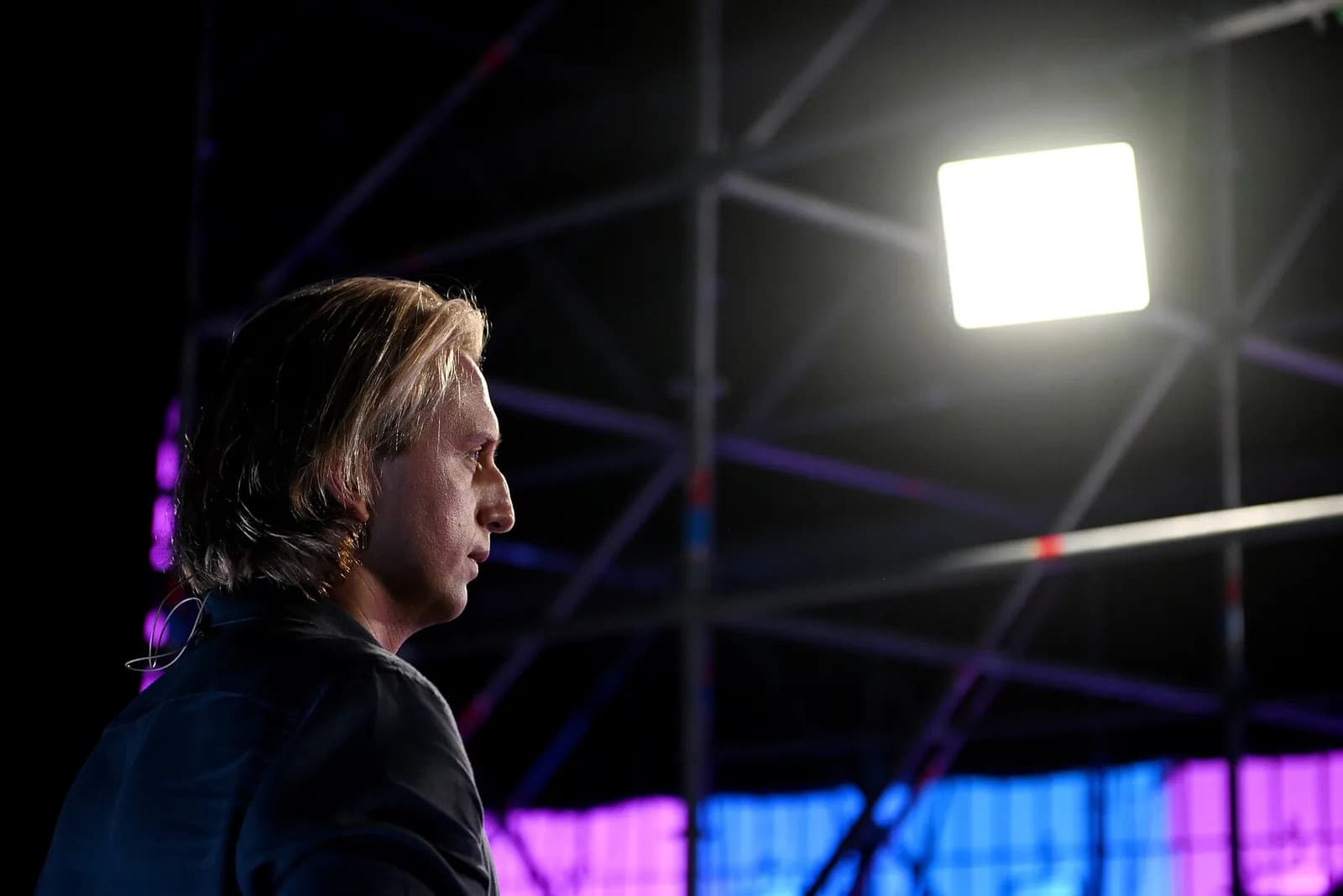 Nik Storonsky stands backstage at Web Summit, facing the stage lights.